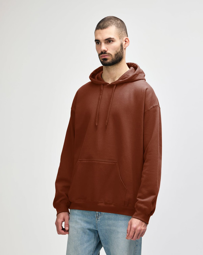 A brown hooded sweatshirt with a front pocket and drawstrings, worn by a model in casual attire.
