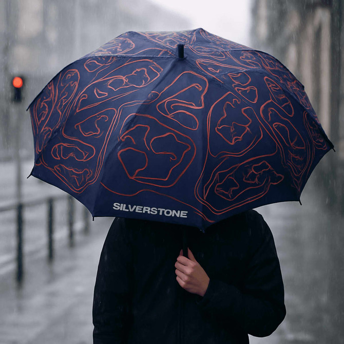A full colour umbrella with a navy blue design featuring various logos and a geometric pattern.