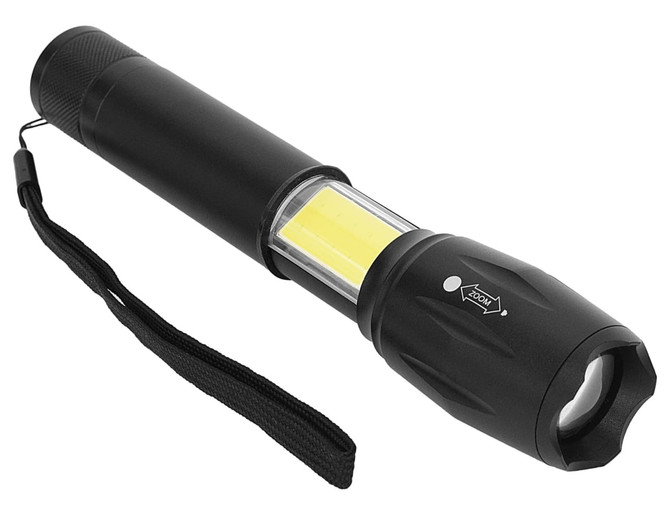 A black torch with a cylindrical body, featuring a bright yellow LED panel and a wrist strap.