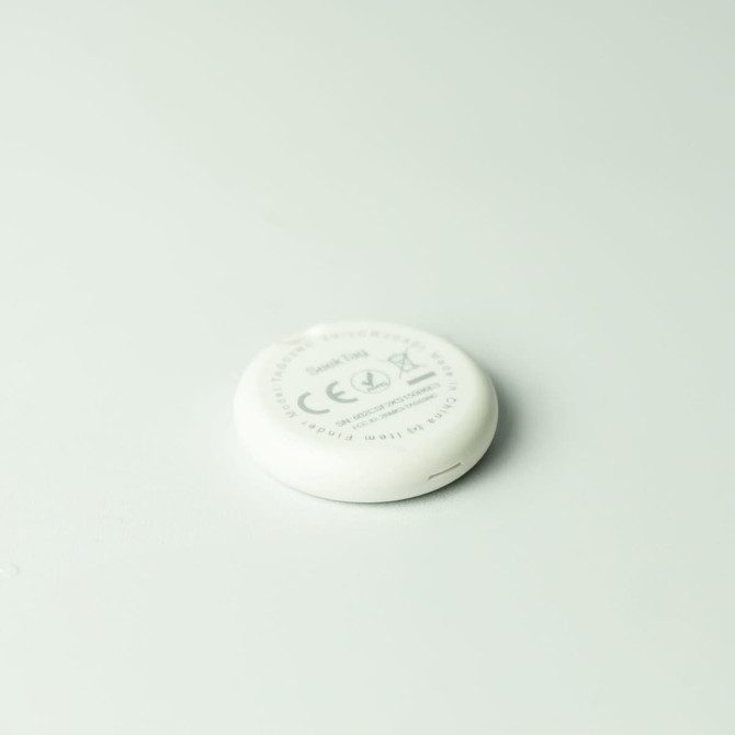 A white circular tracker with a branding logo, featuring a flat design on a light background.