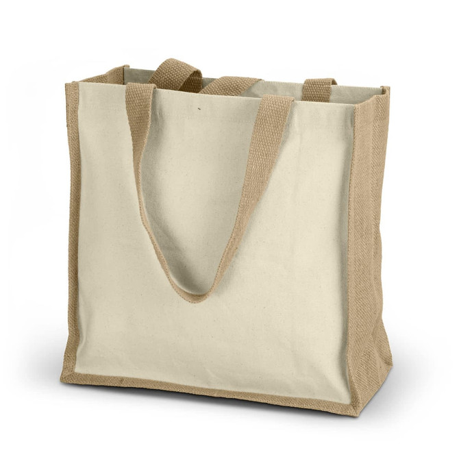 A beige tote bag made of canvas with sturdy handles and a natural jute base. It features a logo.