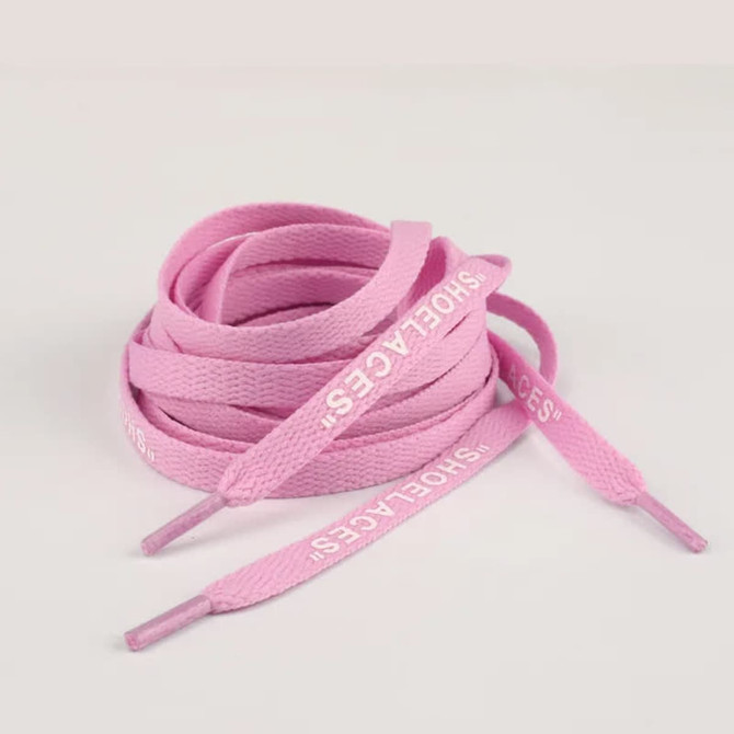 A bundle of pink printed shoelaces with text on the ends, displayed on a light background.