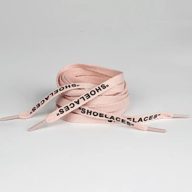 A pair of printed shoelaces in a soft pink colour with black text, neatly coiled with pointed ends.