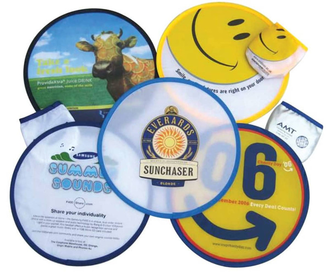 A collection of colourful foldable nylon fun flyers, featuring smiley faces and various designs, with one logo visible.