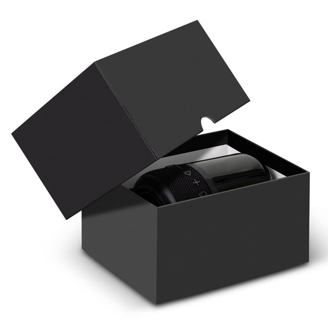A black box with an open lid containing a black Bluetooth speaker, featuring control buttons on the front.