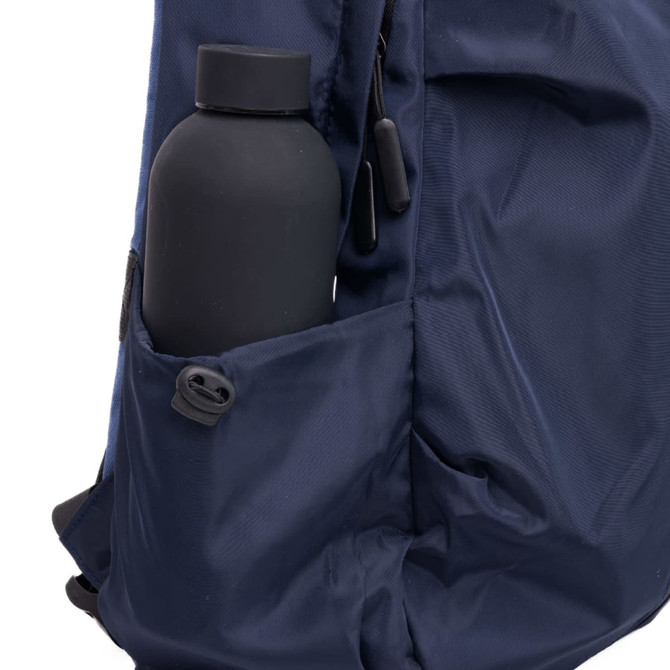 A navy blue backpack featuring a side pocket with a black drink bottle. The backpack includes zippers and durable material.