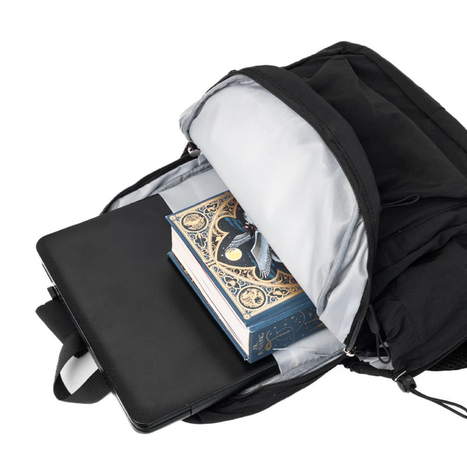 A black backpack opened to reveal a book and a laptop inside, featuring a logo on the exterior.