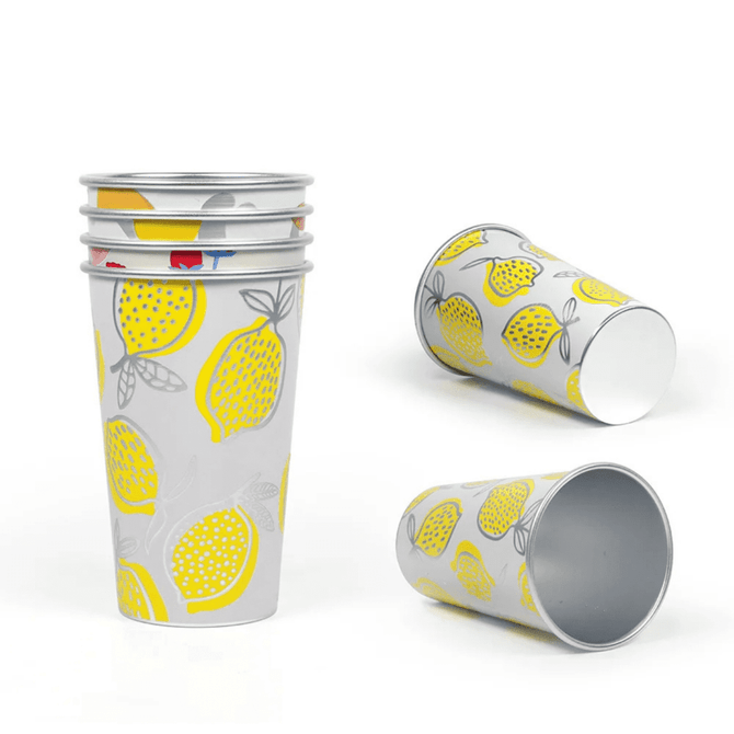A collection of yellow and grey lemon-patterned cups stacked and positioned at various angles. Each cup has a metallic finish and a logo.