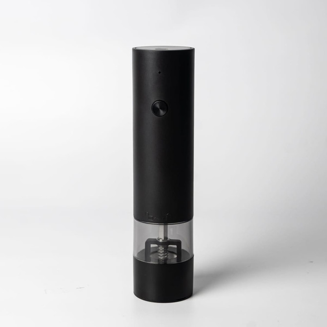 A rechargeable salt and pepper grinder in black with a transparent base, featuring a control knob and a logo.
