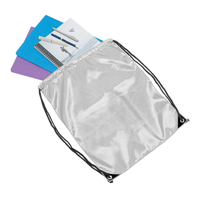 A silver drawstring bag containing notebooks and pens, featuring a branding logo on the exterior.