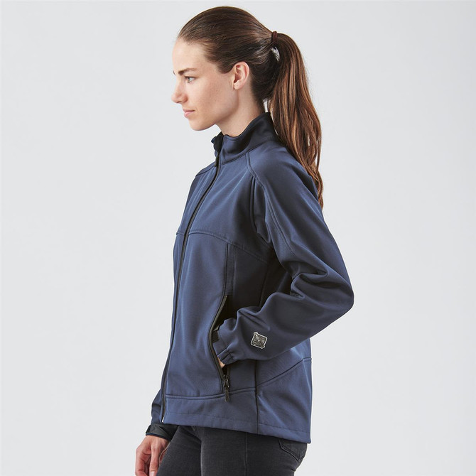 A navy women's jacket with a zip front, featuring a high collar and side pockets. The model is shown from the side.