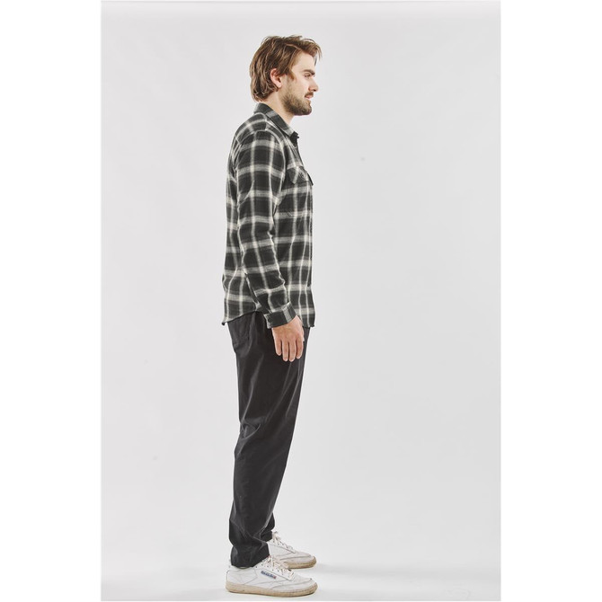 Men's long-sleeve button-up shirt in black and white plaid, featuring a side view of a model wearing it.