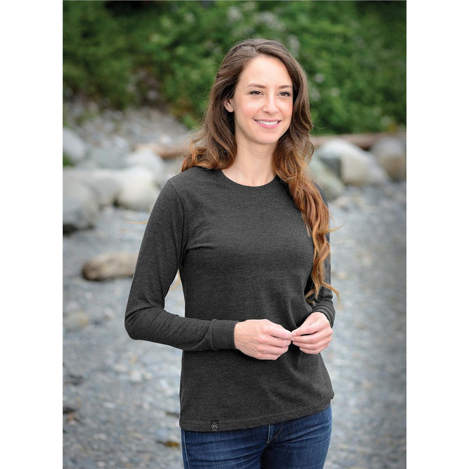 A long-sleeve women's t-shirt in dark grey, featuring a casual design and a subtle logo.