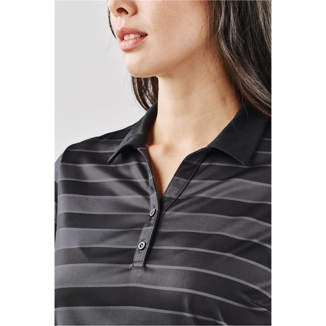 A close-up of a woman's black striped polo shirt with a collar and buttons, featuring a logo.