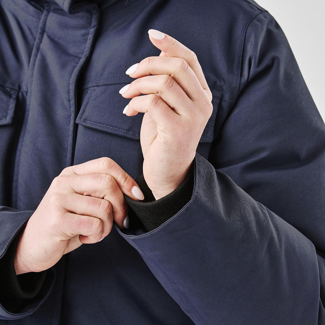 A navy Women's Denali Parka being worn, highlighting the cuffs and detailing of the puffer jacket.