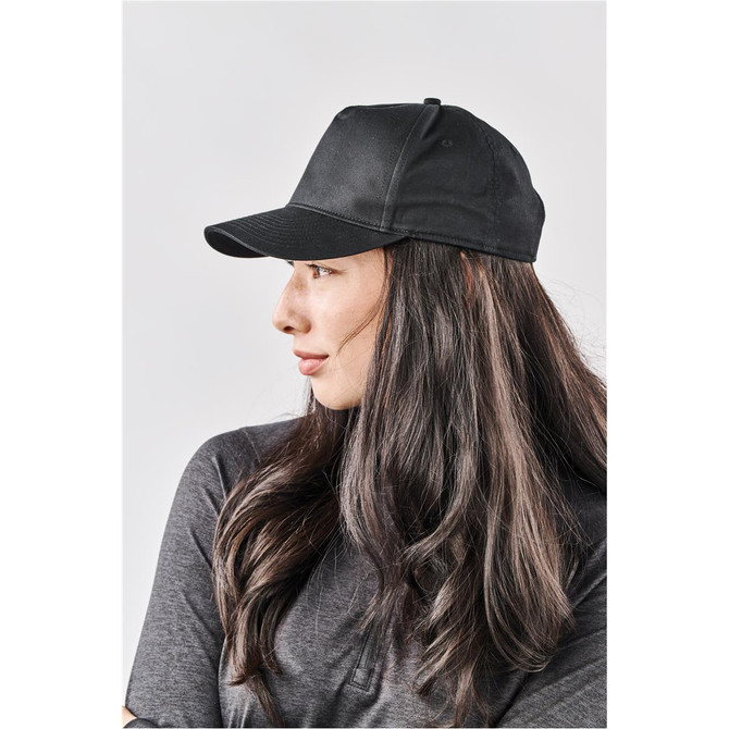 A black cap with a curved brim and adjustable strap, worn by a woman with long hair.