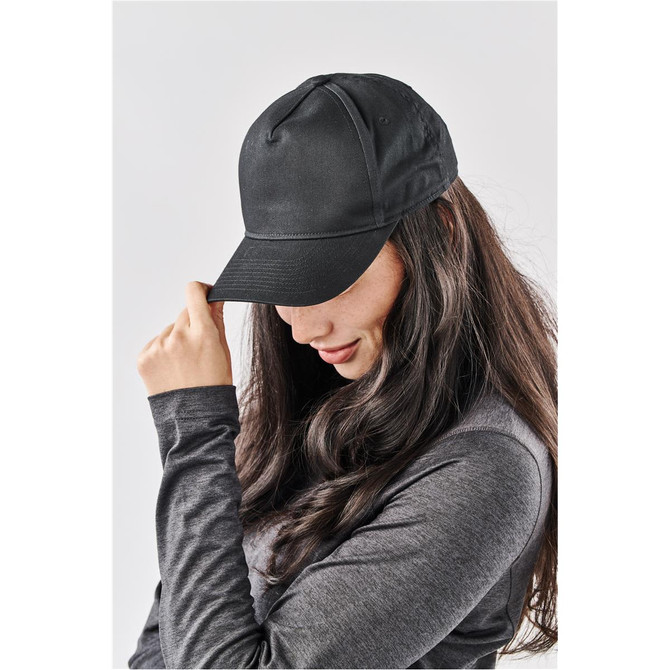 A black cap with a curved brim and a logo, worn by a woman with long, dark hair.