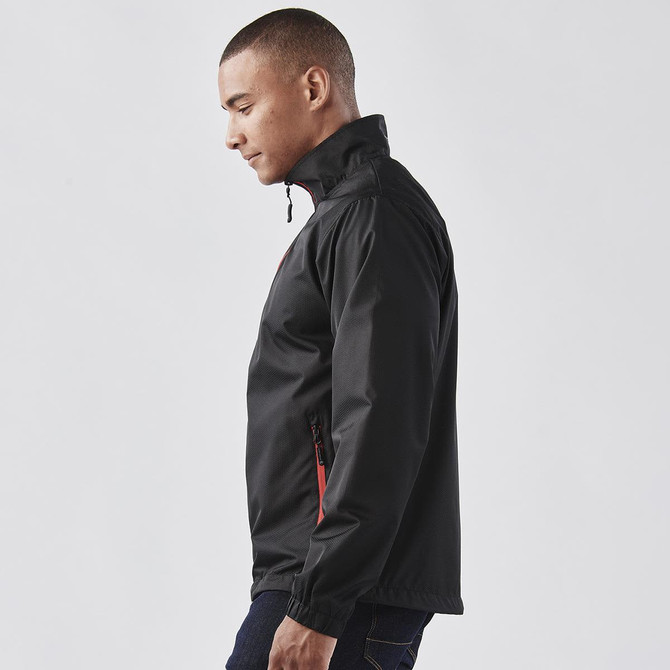A men's black jacket with red accents, featuring a high collar and zipper pockets. It has a logo on the front.