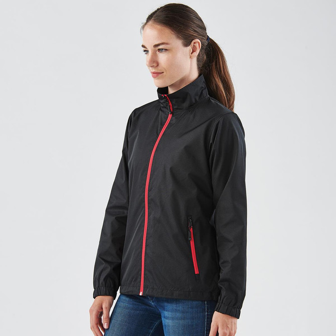 A black rain jacket with a red zip, featuring a high collar and side pockets, displayed on a model.