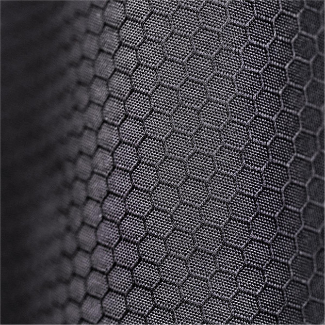 A close-up of a textured black fabric featuring a hexagonal pattern. The fabric appears durable and supportive.