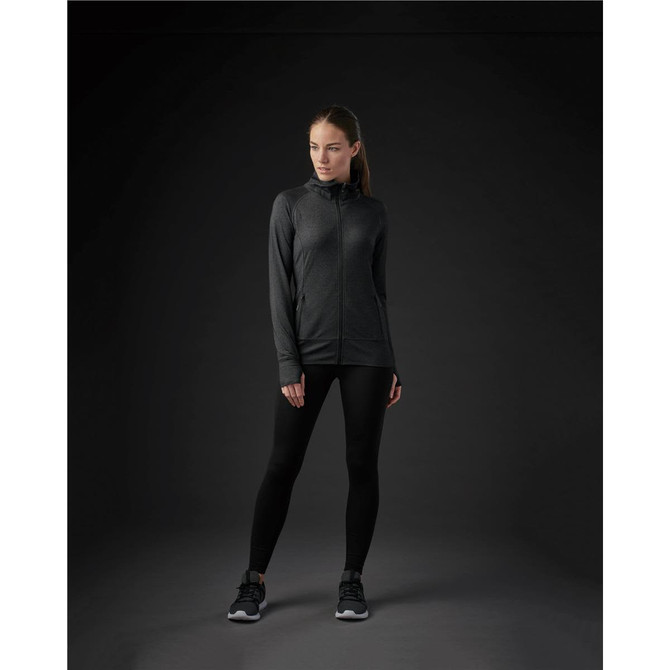 A women's Pacifica jacket in black, featuring a zip front and a modern fit, paired with black leggings and shoes.