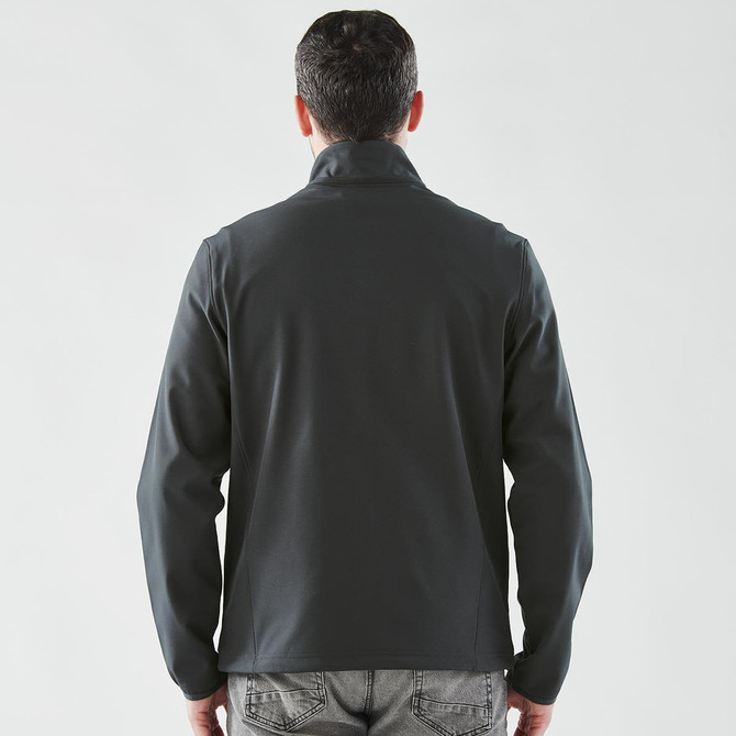 A men's softshell jacket in dark grey, featuring a collar and a sleek back design. It has a logo.