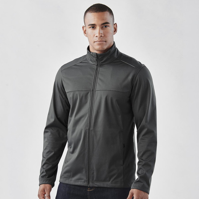 A man wearing a grey lightweight softshell jacket, featuring a zip front and a casual fit. The jacket has a logo.