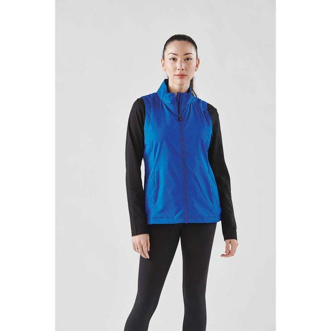 A blue women's vest with a zip front and black long sleeves, featuring a logo on the chest.