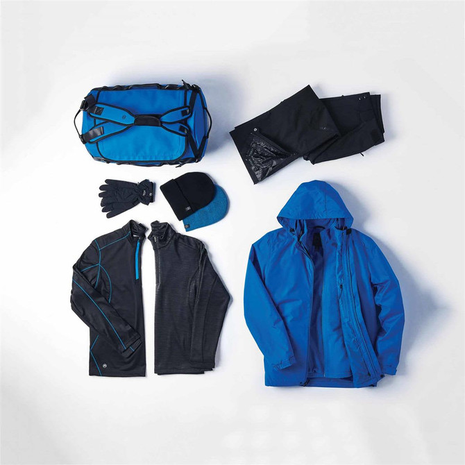 A blue 3 in 1 jacket, black gloves, a beanie, a black top, pants, and a blue duffel bag arranged on a white background.