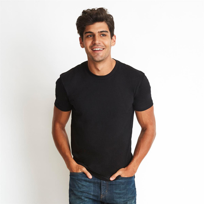 A black men's cotton crew t-shirt displayed on a model, featuring a simple design and tucked hands in pockets.