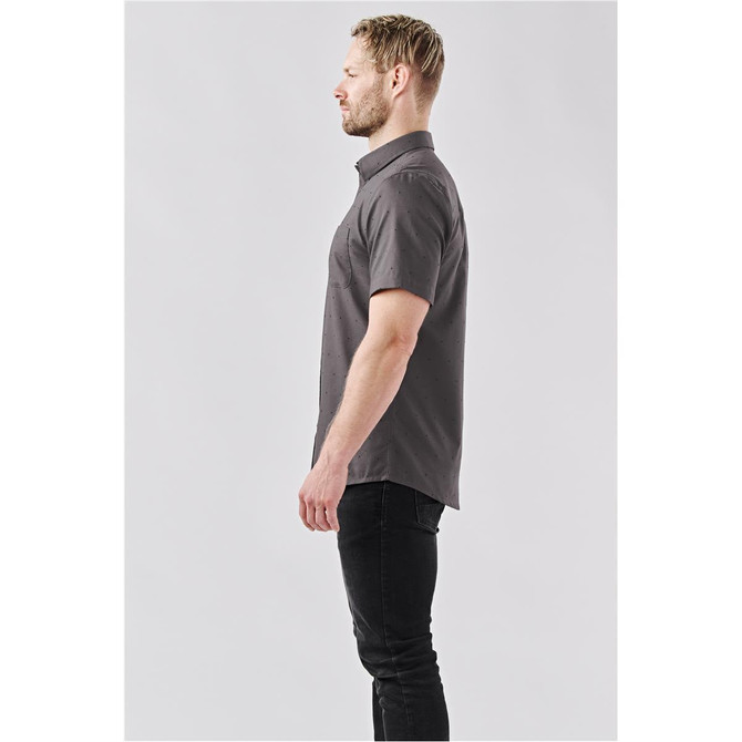 A grey button-up shirt with short sleeves, featuring a subtle pattern, displayed on a model from the side.