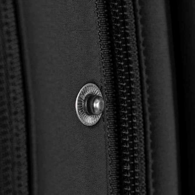 A close-up of a black jacket featuring a silver snap button and zipper details.