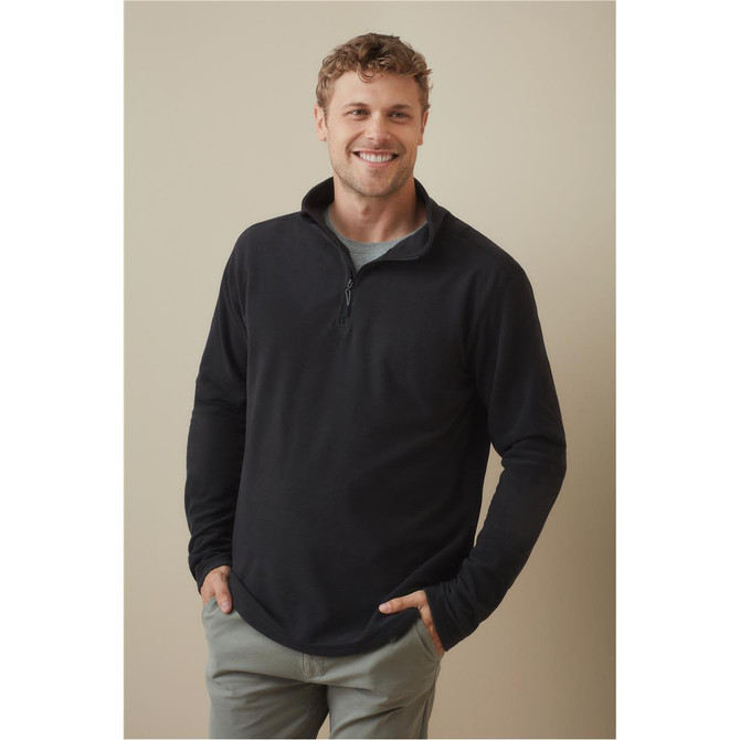 A man wearing a black fleece half-zip jumper, featuring long sleeves and a soft texture. The jumper has a logo.