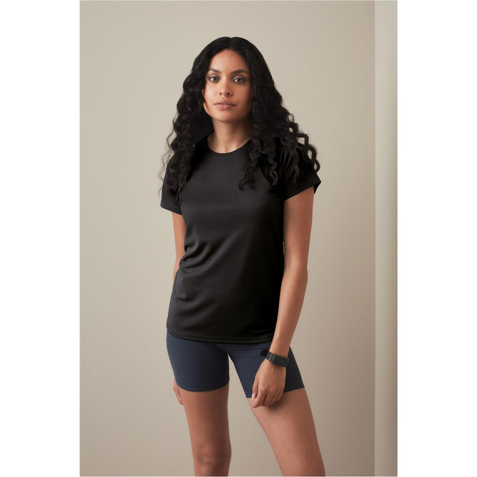 A black women's active t-shirt with raglan sleeves, paired with navy shorts, modelled against a neutral background.
