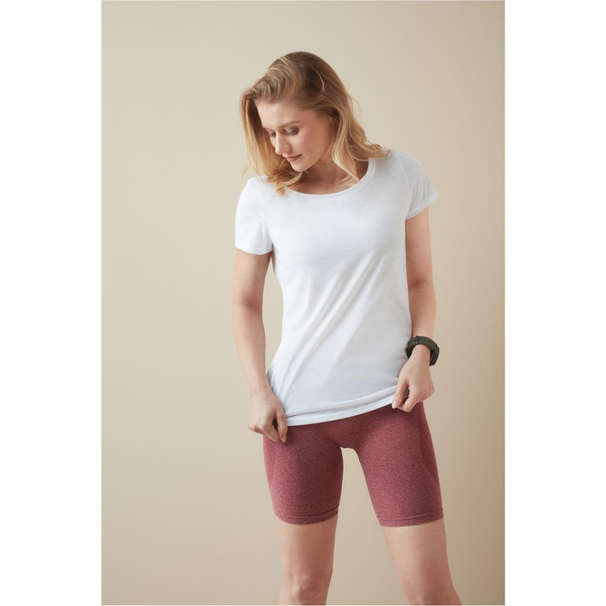 A woman wearing a white T-shirt paired with maroon shorts, featuring a logo on the T-shirt.