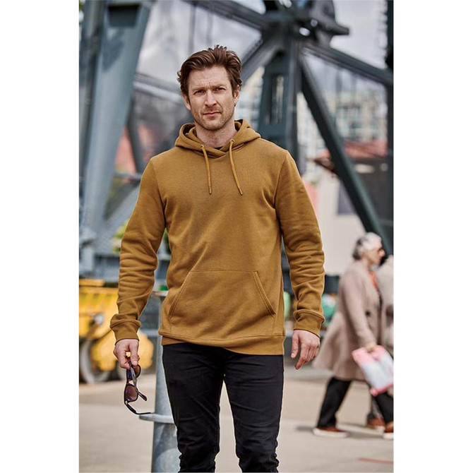 A men's pullover hoody in mustard yellow, featuring a front pocket and drawstring hood, worn by a man outdoors.