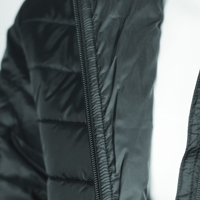 A black puffer jacket featuring a zippered front and quilted design, with a visible logo on the fabric.