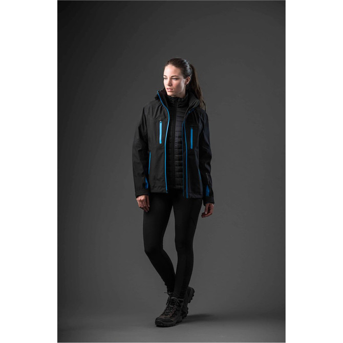 A woman models a black jacket with blue accents, featuring a hood and zip pockets, set against a dark background.