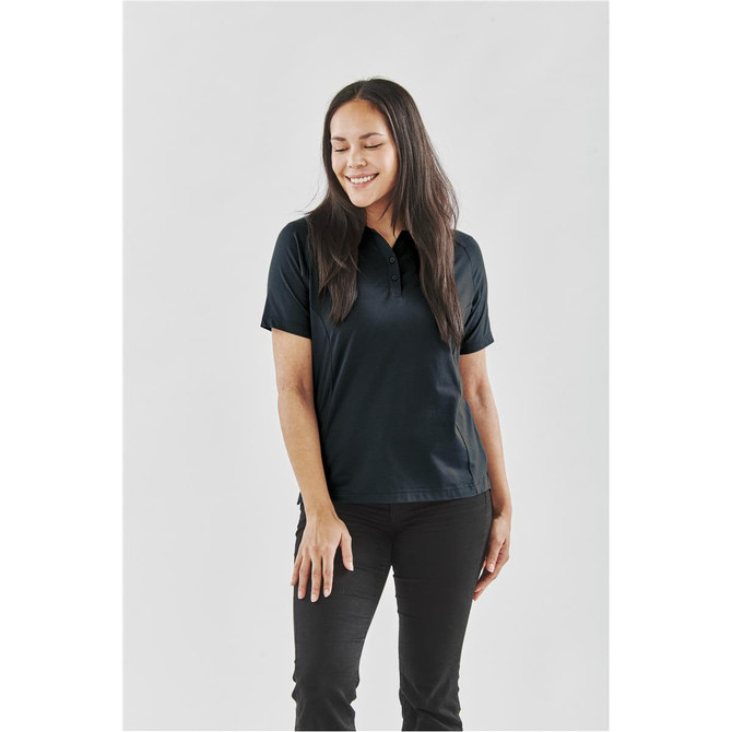 A black women's polo shirt displayed on a model, featuring a collar and short sleeves. The design includes a logo.
