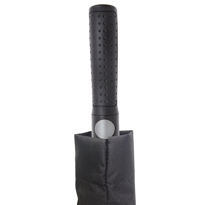 A black umbrella with a textured handle, stored in a protective sleeve. The handle features a circular button.