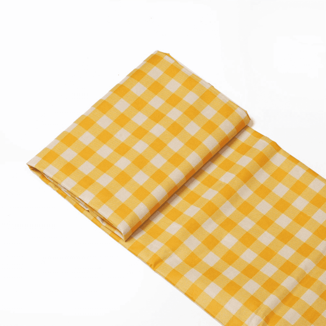 A yellow and white checked picnic blanket folded neatly, featuring a slight sheen and a compact design.