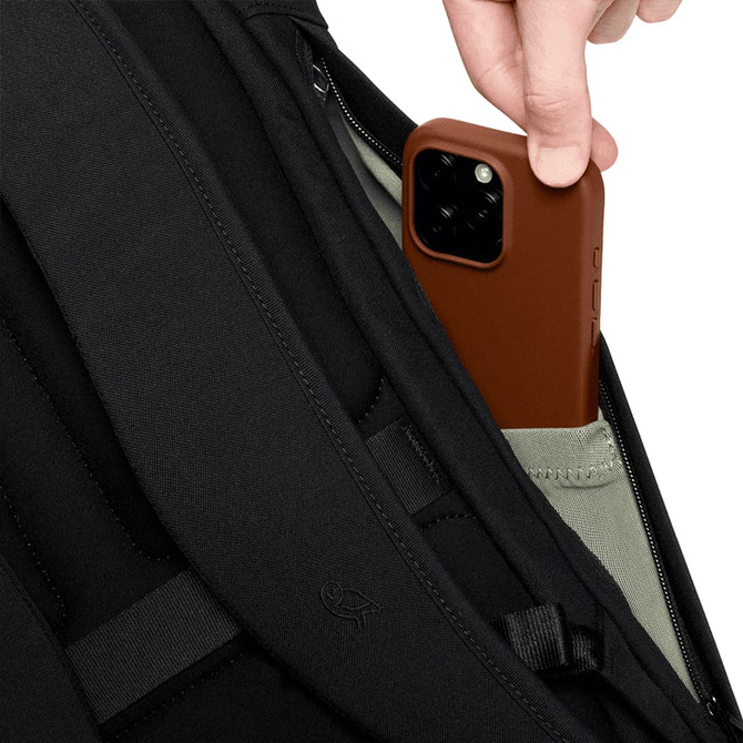 A black backpack with a grey pocket, featuring a person placing a brown phone into the pocket.