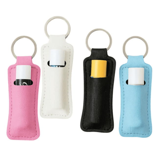 A collection of four neoprene keychains in pink, white, black, and blue, each holding a small tube.