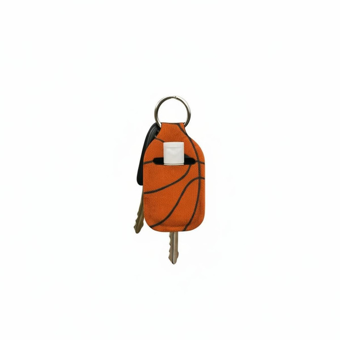 An orange neoprene keychain shaped like a basketball, holding keys with a metal keyring.