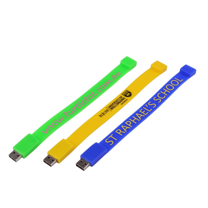 Three rectangular silicone wristband flash drives in bright green, yellow, and blue, each with a logo or branding.