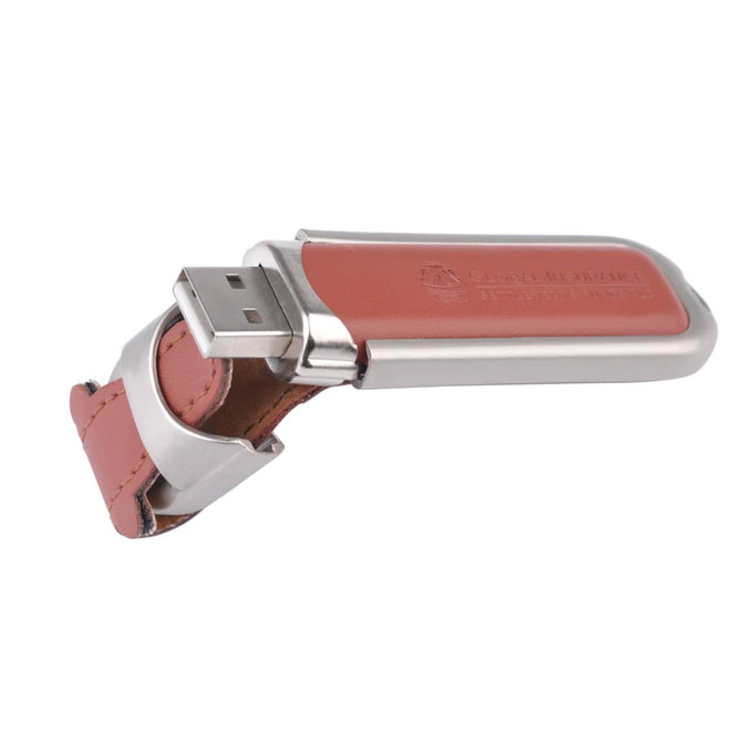 A Taurus flash drive featuring a silver metallic casing with a leather strap in a warm tan colour.