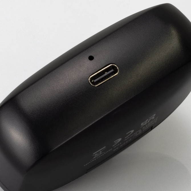 A black charging case with a USB-C port, used for wireless earbuds. The case has a sleek design and minimal branding.
