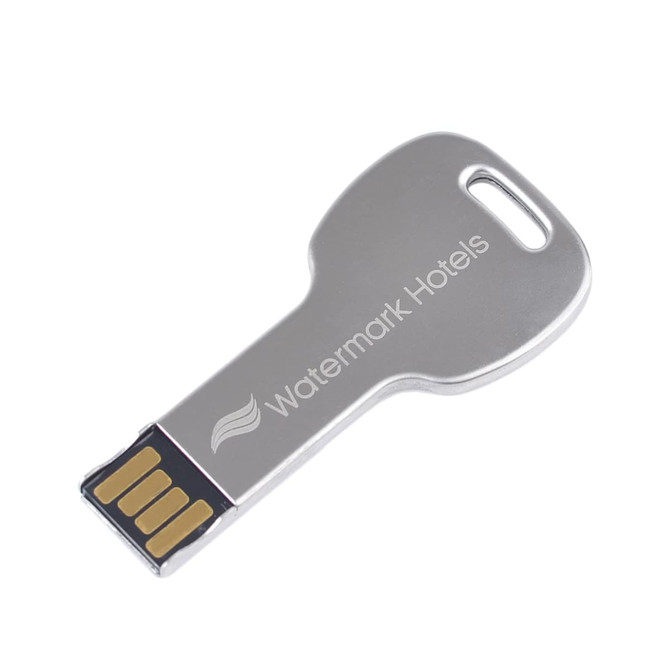A round metallic key-shaped flash drive with a silver finish and an embedded branding logo.