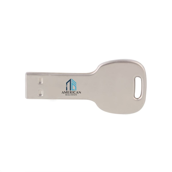 A round silver flash drive designed in the shape of a key, featuring a logo on one side.