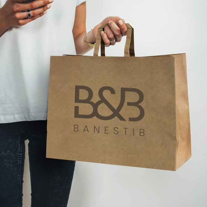 A large brown paper bag with flat handles, featuring a logo on its surface.